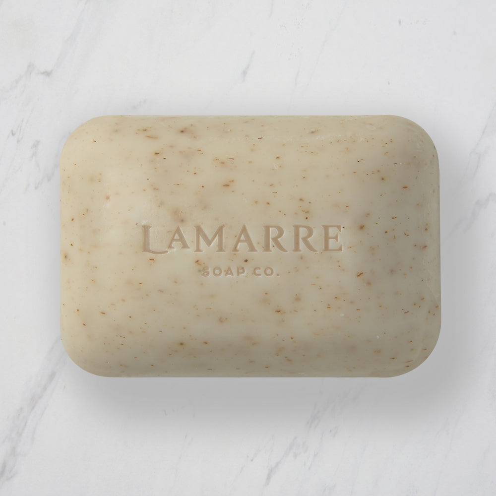 Lamarre Soap Co. 5.3oz Lavender Natural Bar Soap with exfoliating lavender flowers, lavender essential oil, shea butter and coconut oil on marble counter. 